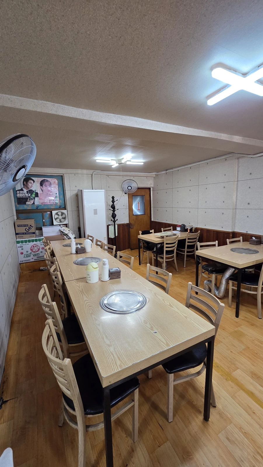 Interior seats with round grilling braziers at each table and an emergency-exit door